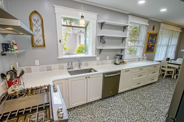 kitchen featuring pendant lighting, dishwasher, white cabinetry, sink, and wall chimney exhaust hood