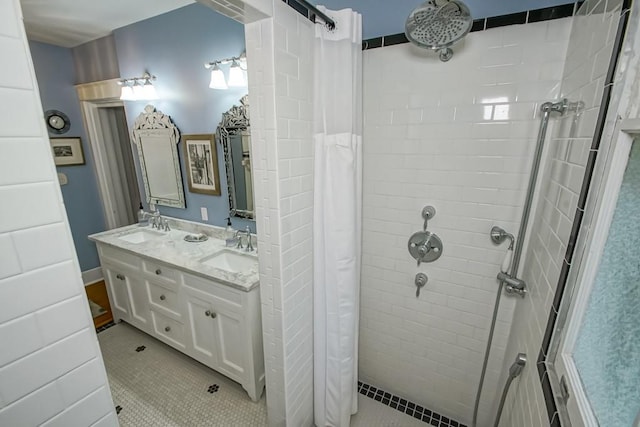 bathroom featuring walk in shower, dual vanity, and tile patterned flooring