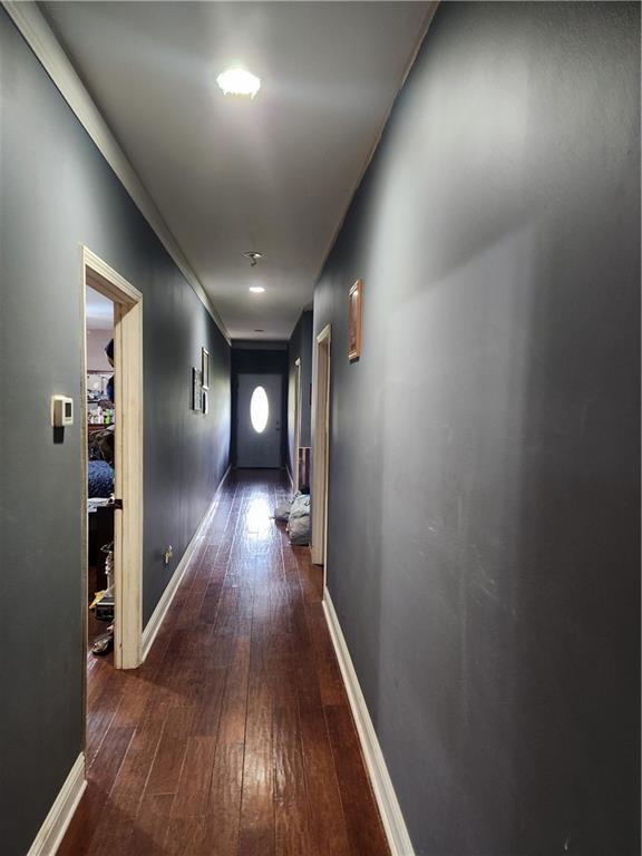 hallway with dark hardwood / wood-style flooring