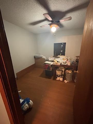 bedroom featuring ceiling fan, cooling unit, and hardwood / wood-style flooring