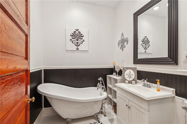 bathroom featuring vanity and a bath