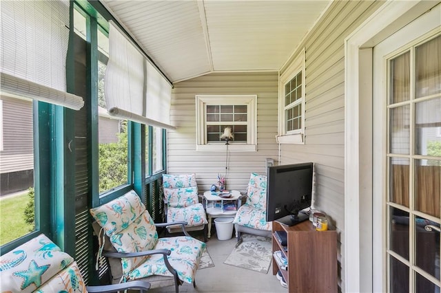 sunroom / solarium featuring lofted ceiling and plenty of natural light