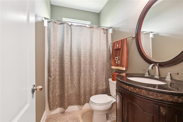 bathroom featuring tile patterned floors, vanity, and toilet