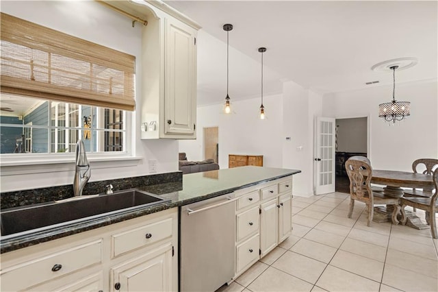 kitchen featuring light tile patterned flooring, pendant lighting, sink, stainless steel dishwasher, and cream cabinetry