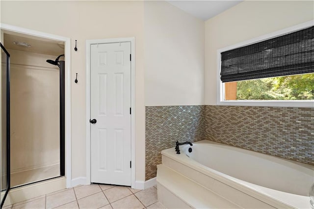 bathroom featuring shower with separate bathtub and tile patterned flooring