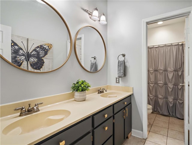 bathroom featuring toilet, vanity, tile patterned floors, and a shower with shower curtain