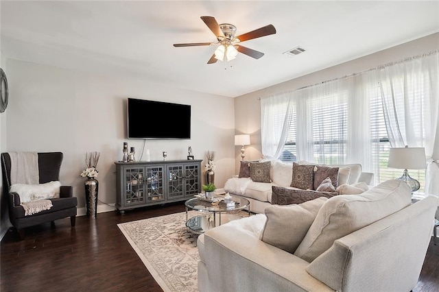 living room featuring ceiling fan and dark hardwood / wood-style flooring