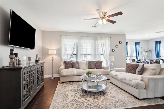 living room featuring ceiling fan and dark hardwood / wood-style flooring