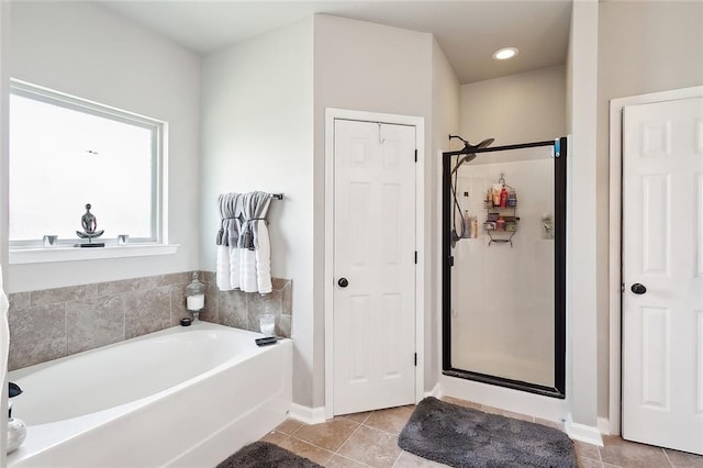 bathroom featuring tile patterned floors and separate shower and tub