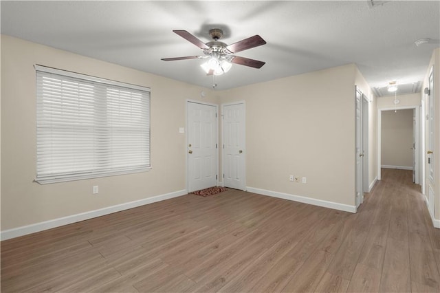 unfurnished bedroom with ceiling fan and hardwood / wood-style floors