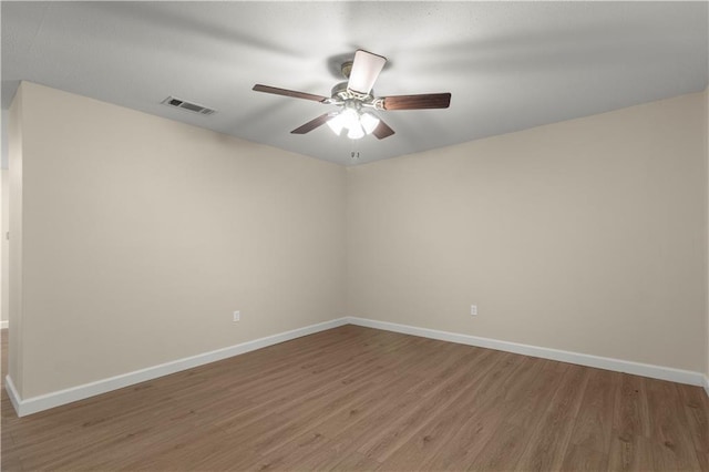 spare room featuring ceiling fan and wood-type flooring