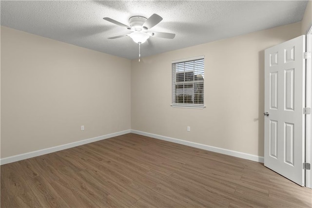 unfurnished room featuring ceiling fan, hardwood / wood-style floors, and a textured ceiling