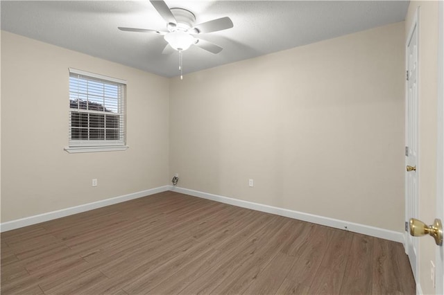 empty room with ceiling fan and wood-type flooring