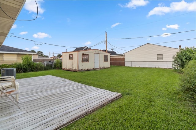 view of yard featuring a wooden deck, cooling unit, and a shed