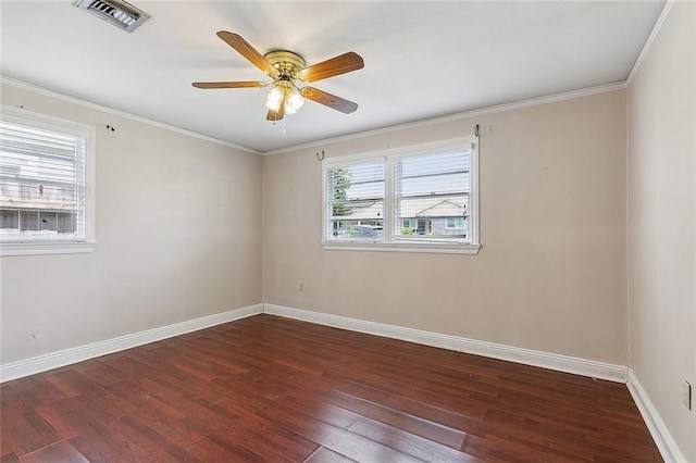 unfurnished room with dark wood-style floors, baseboards, visible vents, and ornamental molding