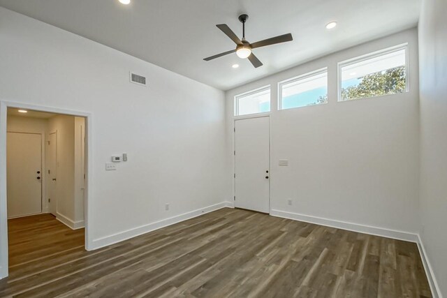 spare room with ceiling fan, wood-type flooring, and lofted ceiling