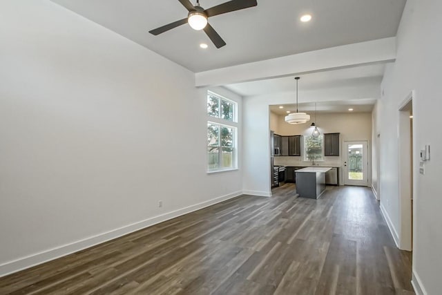 unfurnished living room with ceiling fan and dark hardwood / wood-style flooring