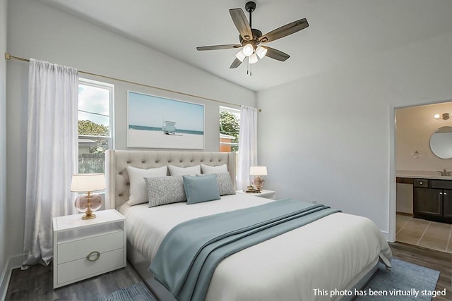 bedroom with ceiling fan, vaulted ceiling, wood-type flooring, and ensuite bathroom