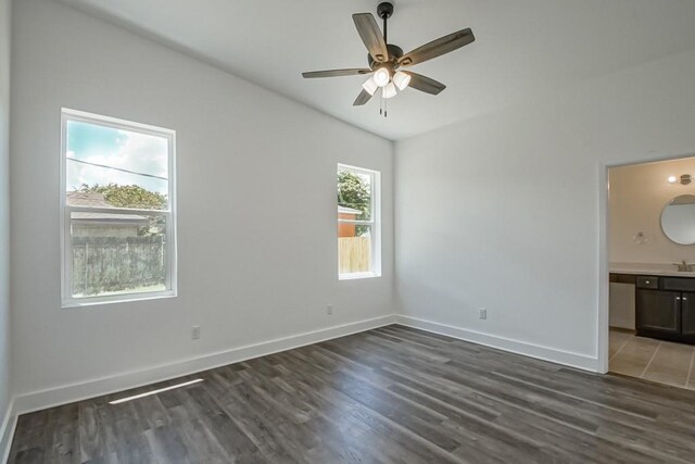 empty room featuring ceiling fan and dark wood-type flooring