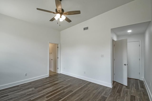 empty room with dark hardwood / wood-style floors and ceiling fan