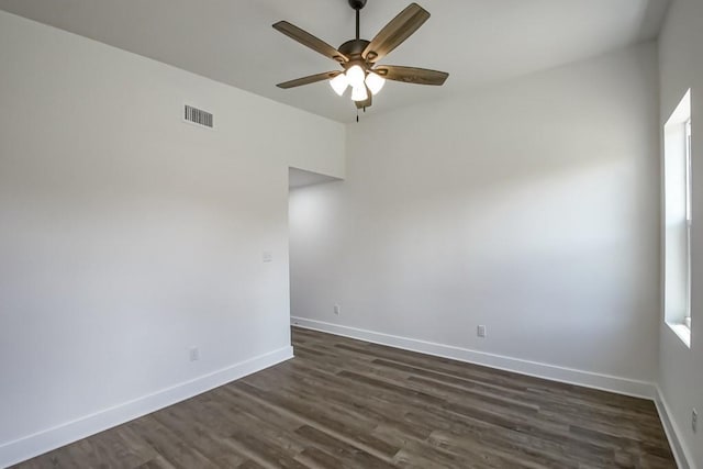 empty room with ceiling fan and dark hardwood / wood-style floors