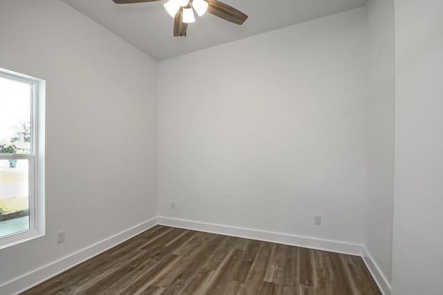 unfurnished room featuring dark wood-type flooring and ceiling fan