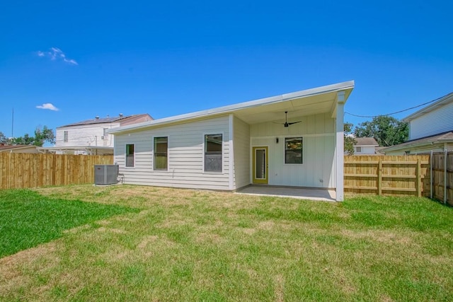 back of property with a patio, a yard, central AC, and ceiling fan