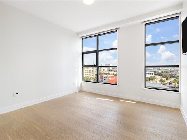 unfurnished room with light hardwood / wood-style flooring