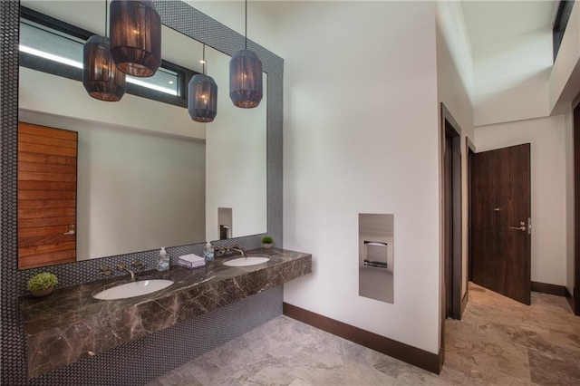 bathroom with sink and a high ceiling