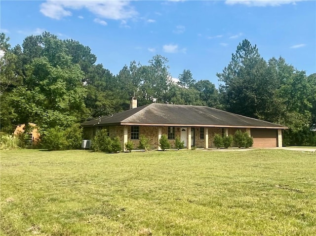 ranch-style home featuring a garage and a front lawn