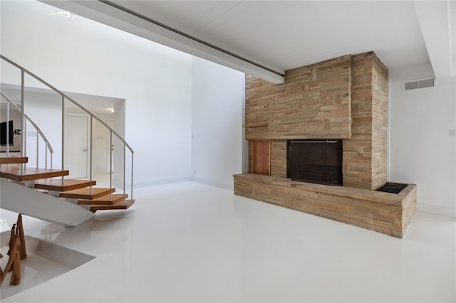 living room with a large fireplace and beamed ceiling