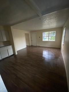 interior space featuring beam ceiling and hardwood / wood-style flooring