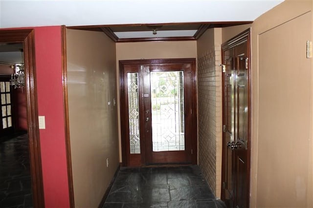 tiled entryway featuring ornamental molding