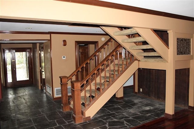 interior space with ornamental molding and tile patterned flooring