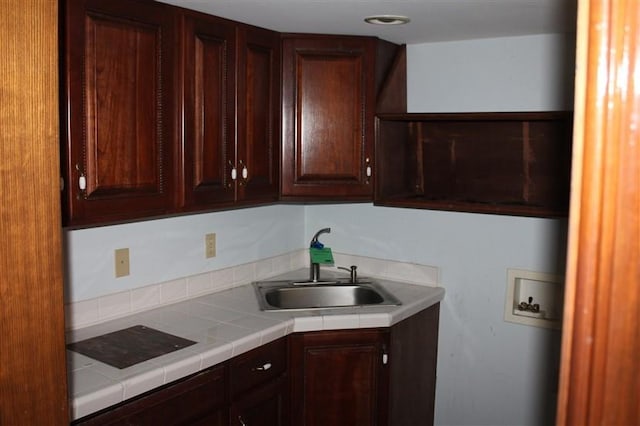 kitchen with tile counters and sink