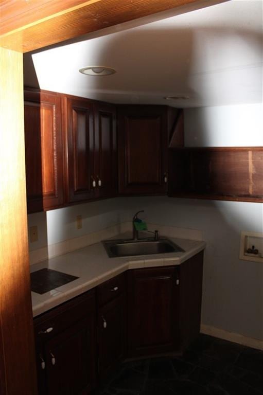 kitchen featuring black electric cooktop, sink, and dark tile patterned floors