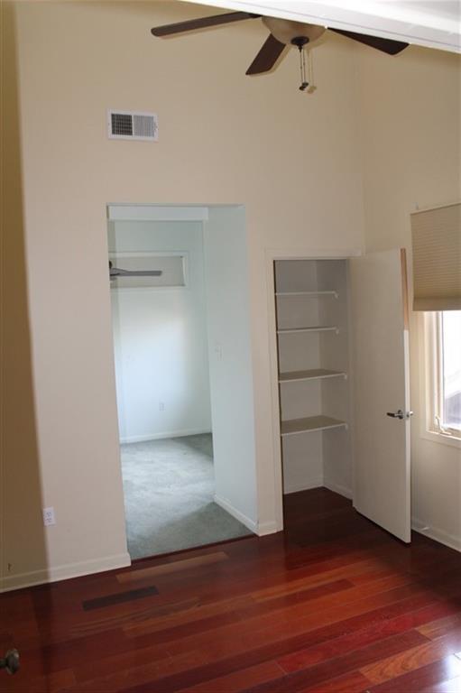 unfurnished bedroom with ceiling fan and carpet floors