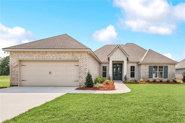 view of front of home with a garage and a front yard