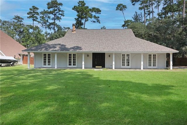 view of front of home featuring a front yard and french doors