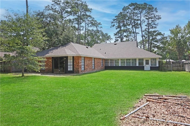 rear view of property with a yard