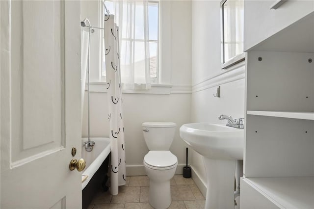 full bathroom featuring toilet, shower / tub combo with curtain, tile patterned floors, and a healthy amount of sunlight