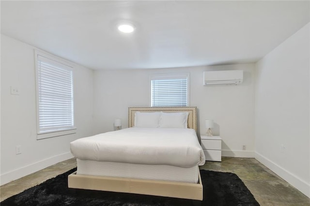 bedroom with a wall unit AC and baseboards