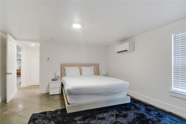 bedroom with a wall mounted AC and tile patterned floors