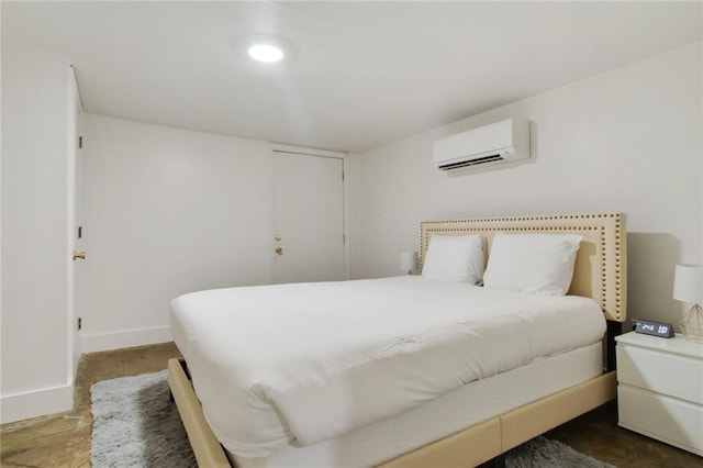 bedroom featuring tile patterned floors and a wall unit AC