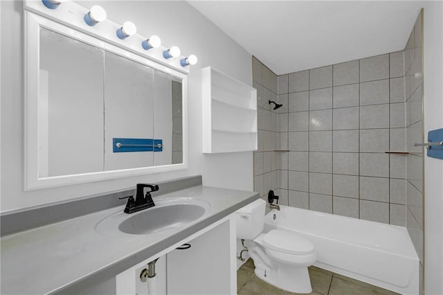 full bathroom featuring tiled shower / bath, vanity, toilet, and tile patterned flooring