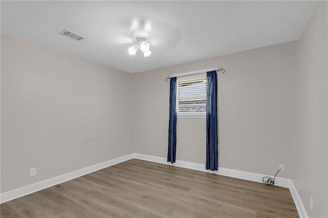 empty room with light hardwood / wood-style flooring and ceiling fan