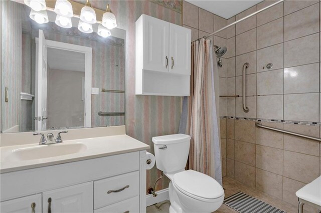 bathroom featuring vanity, toilet, and a shower with curtain