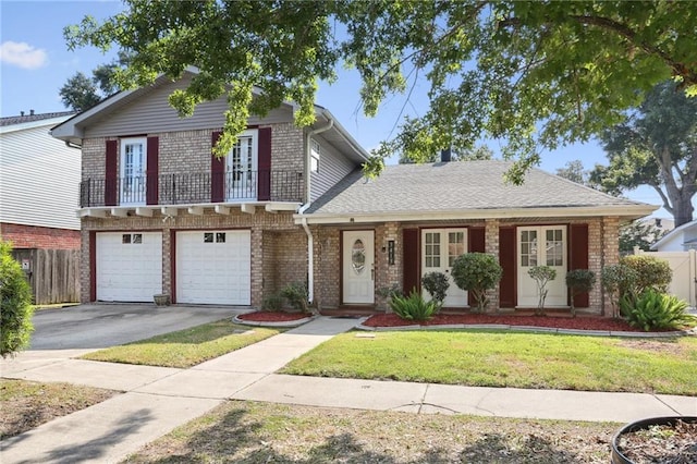 view of front of home featuring a garage, a front yard, and a balcony