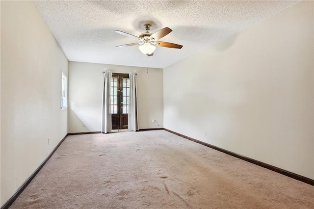 unfurnished room with ceiling fan, a textured ceiling, and carpet flooring