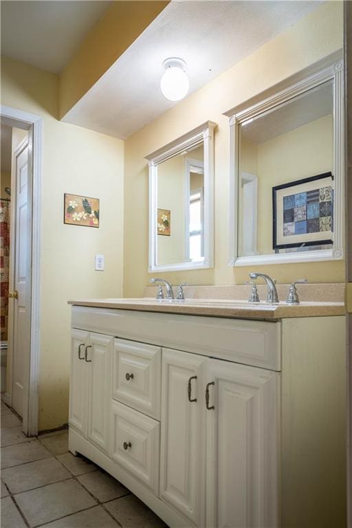 bathroom featuring double vanity and tile patterned flooring